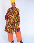 Model wearing yellow dress with multicolor floral print.