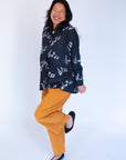 Model wearing black long sleeved shirt with white music print design.