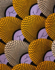 Close up display of long sleeved orange and purple geometric print shirt, fabric.