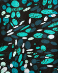 Close up display of abstract blue pebble print dress, fabric.