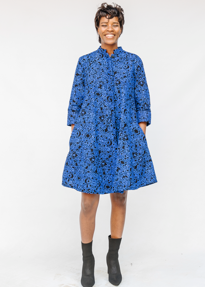 Model wearing black and blue floral dress.