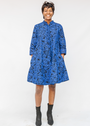 Model wearing black and blue floral dress.