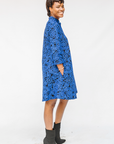 Model wearing black and blue floral dress.