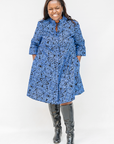 Model wearing black and blue floral dress.