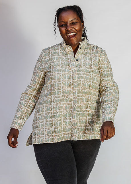 Model wearing long sleeved shirt with small owl print.