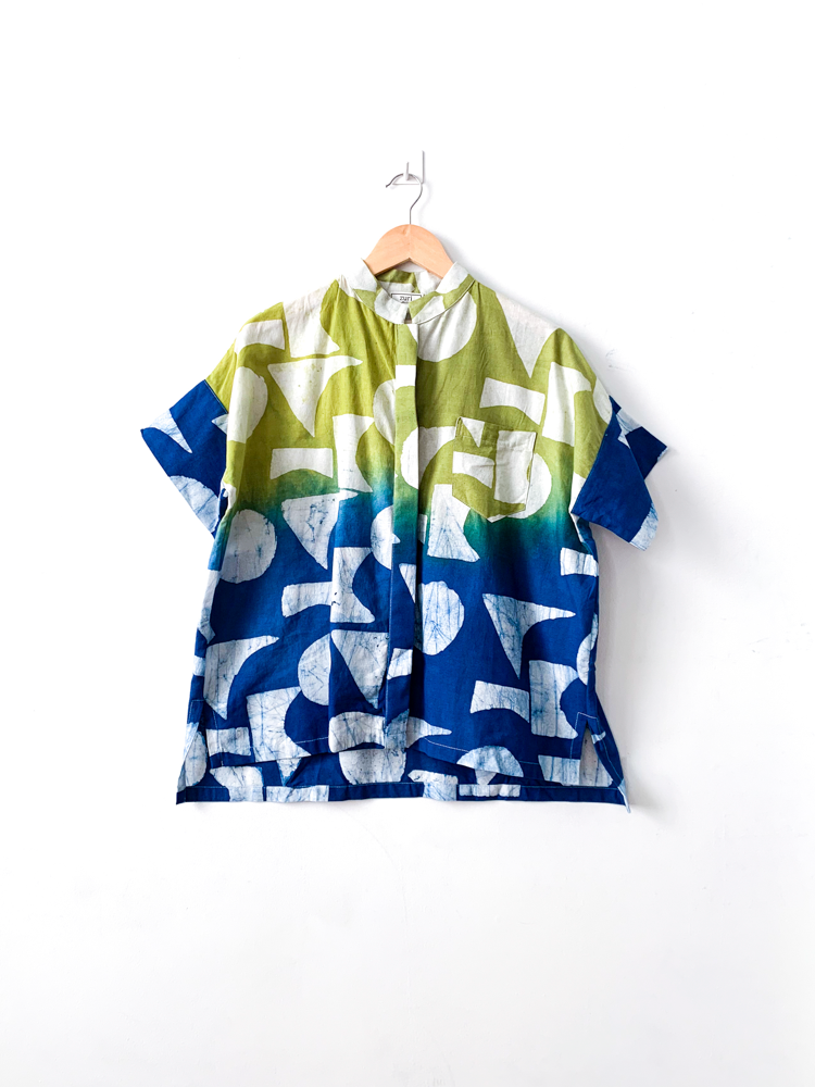 Display of yellow, green and blue geometric print batik shirt.