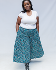 Model wearing aqua, black and white culottes.
