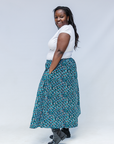 Model wearing aqua, black and white culottes.