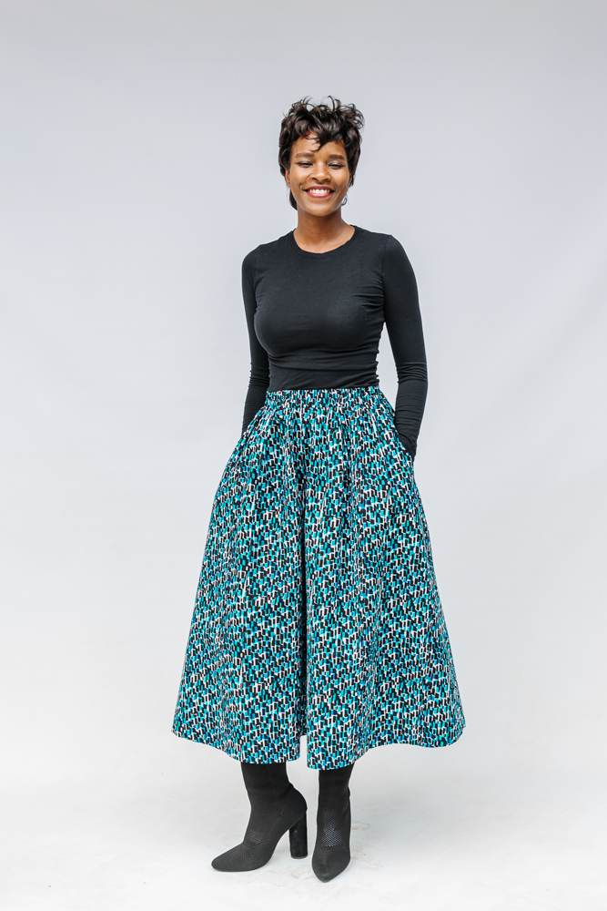 Model wearing aqua, black and white culottes.
