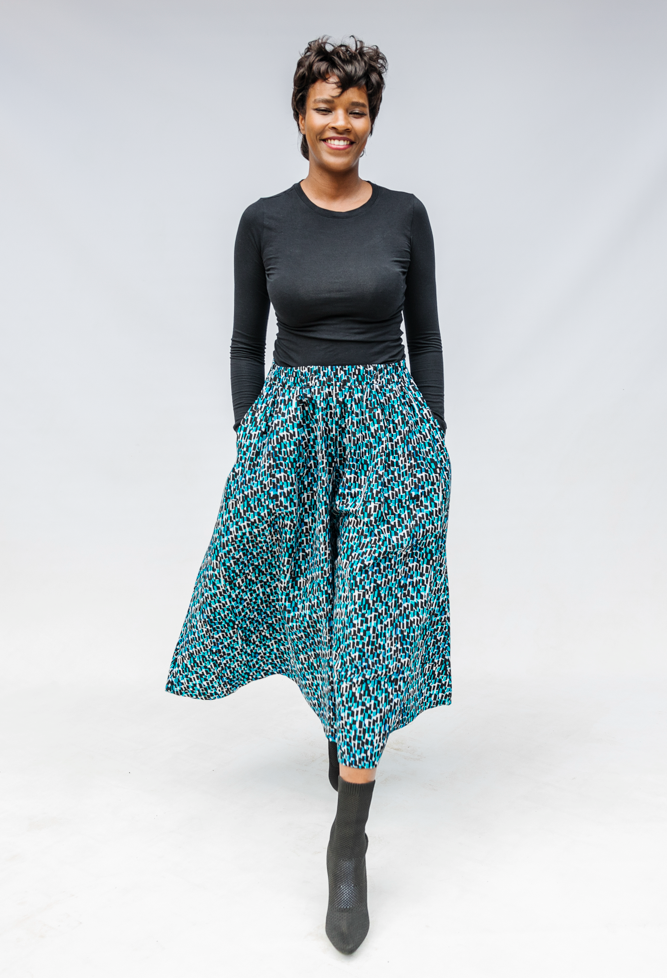 Model wearing aqua, black and white culottes.