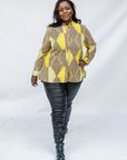 Model wearing yellow, brown and white abstract print shirt.