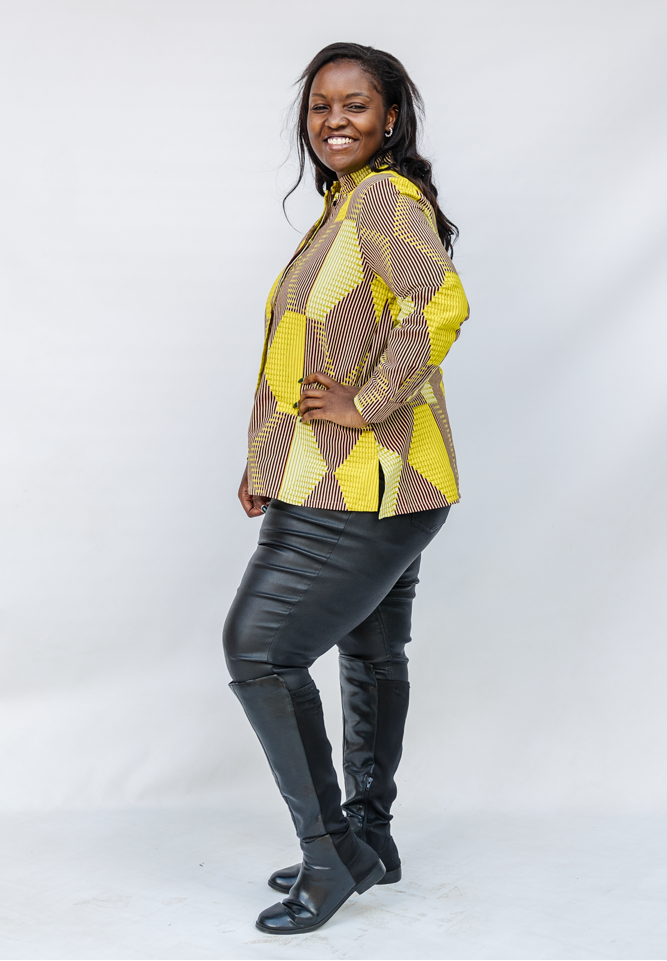 Model wearing yellow, brown and white abstract print shirt.