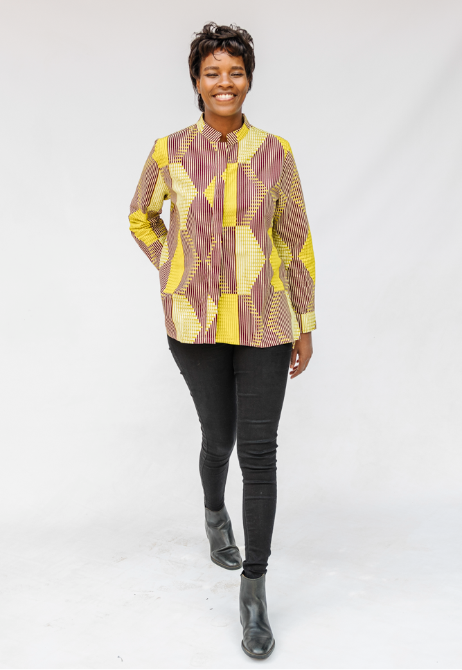 Model wearing yellow, brown and white abstract print shirt.