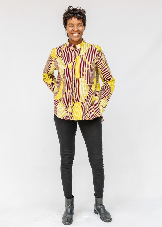 Model wearing yellow, brown and white abstract print shirt.