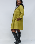 Model wearing olive green linen dress.