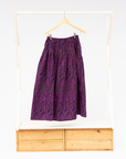 Display of fuchsia skirt with small dot design.