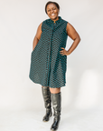 Model wearing sleeveless black dress with teal moon design.