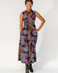 Model wearing pink, orange, white and black geometric print dress.