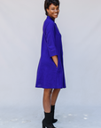 Model wearing deep blue linen dress.