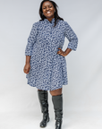 Model wearing blue and white swirl print dress.