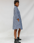Model wearing blue and white swirl print dress.