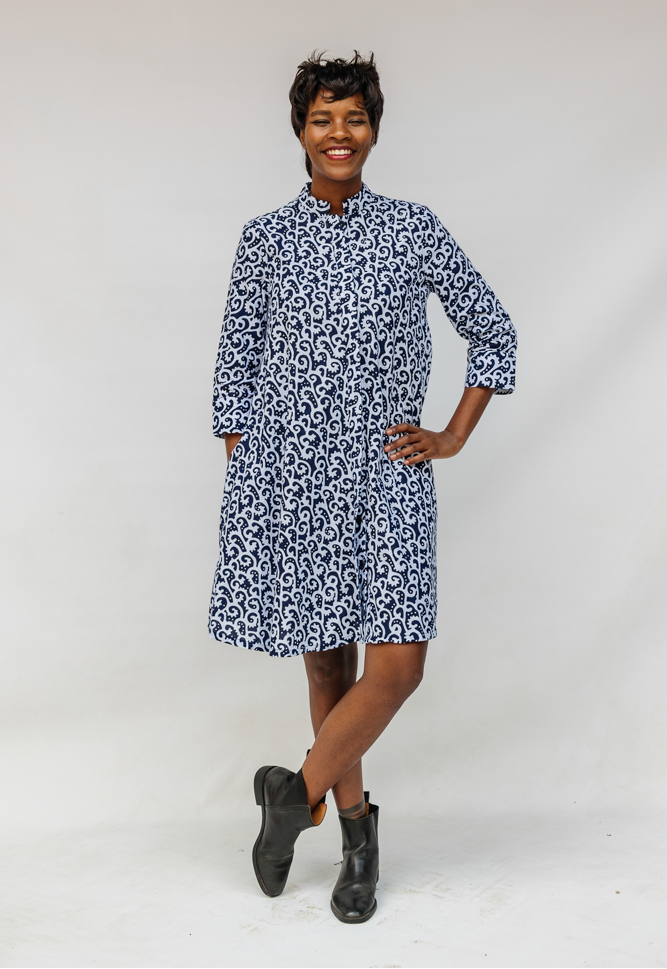 Model wearing blue and white swirl print dress.