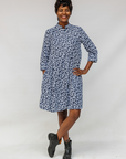 Model wearing blue and white swirl print dress.