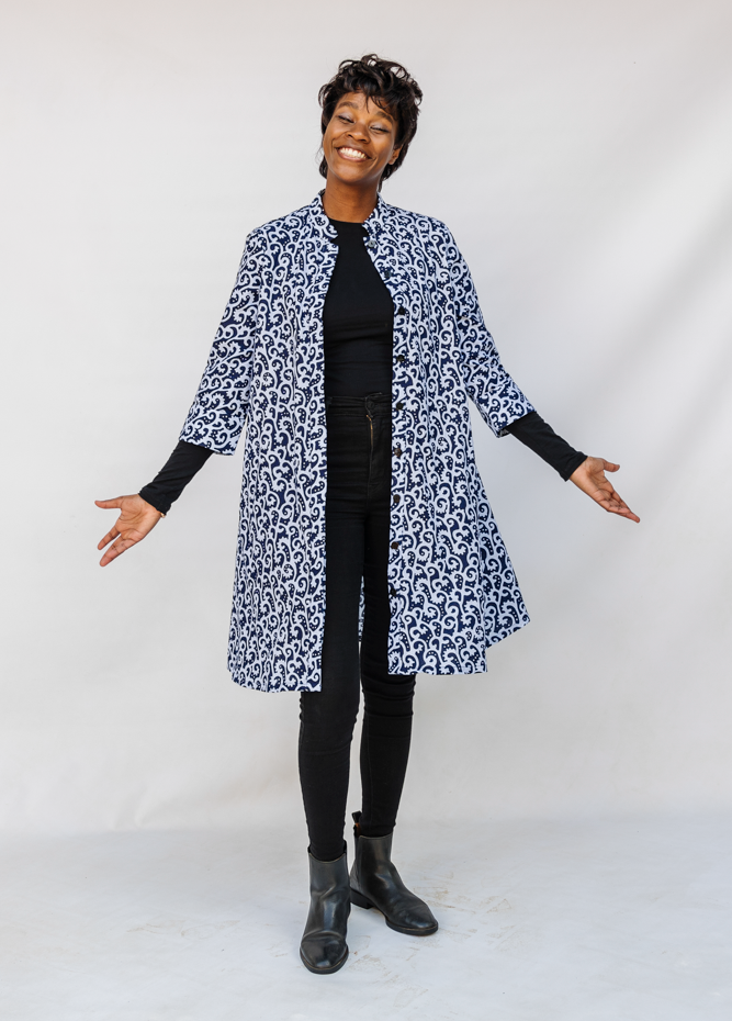 Model wearing blue and white swirl print dress.