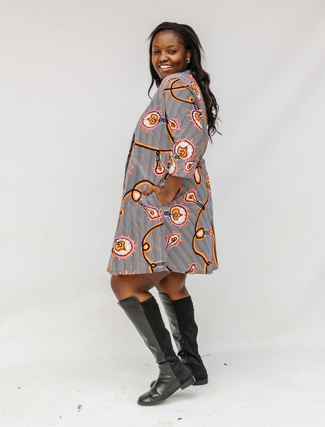 Model wearing black and white light bulb print dress.