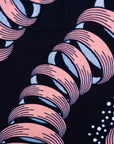 Close up display of black and pink sleeveless print dress.