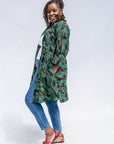 Model wearing green camo print like dress.