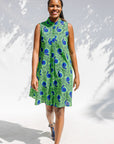 Model wearing sleeveless dress with green and blue snail print.