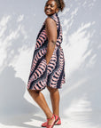 Model wearing black and pink sleeveless print dress.