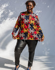 Model wearing multicolored puzzle print shirt.
