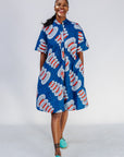 Woman wearing a blue patterned dress on a white background