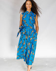 Woman wearing a blue dress with FISH print on a white background