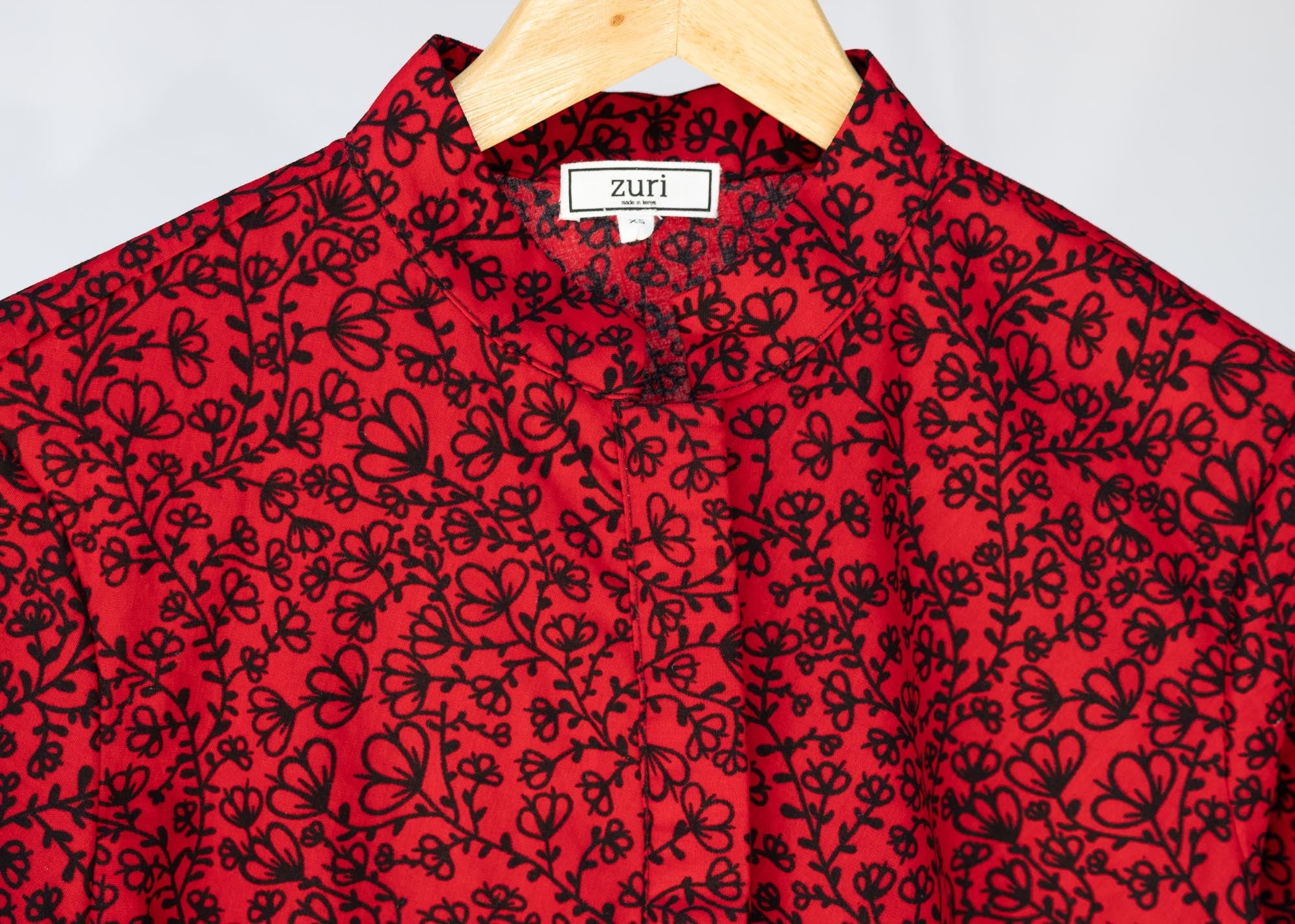 detail of a red and black leaf design dress