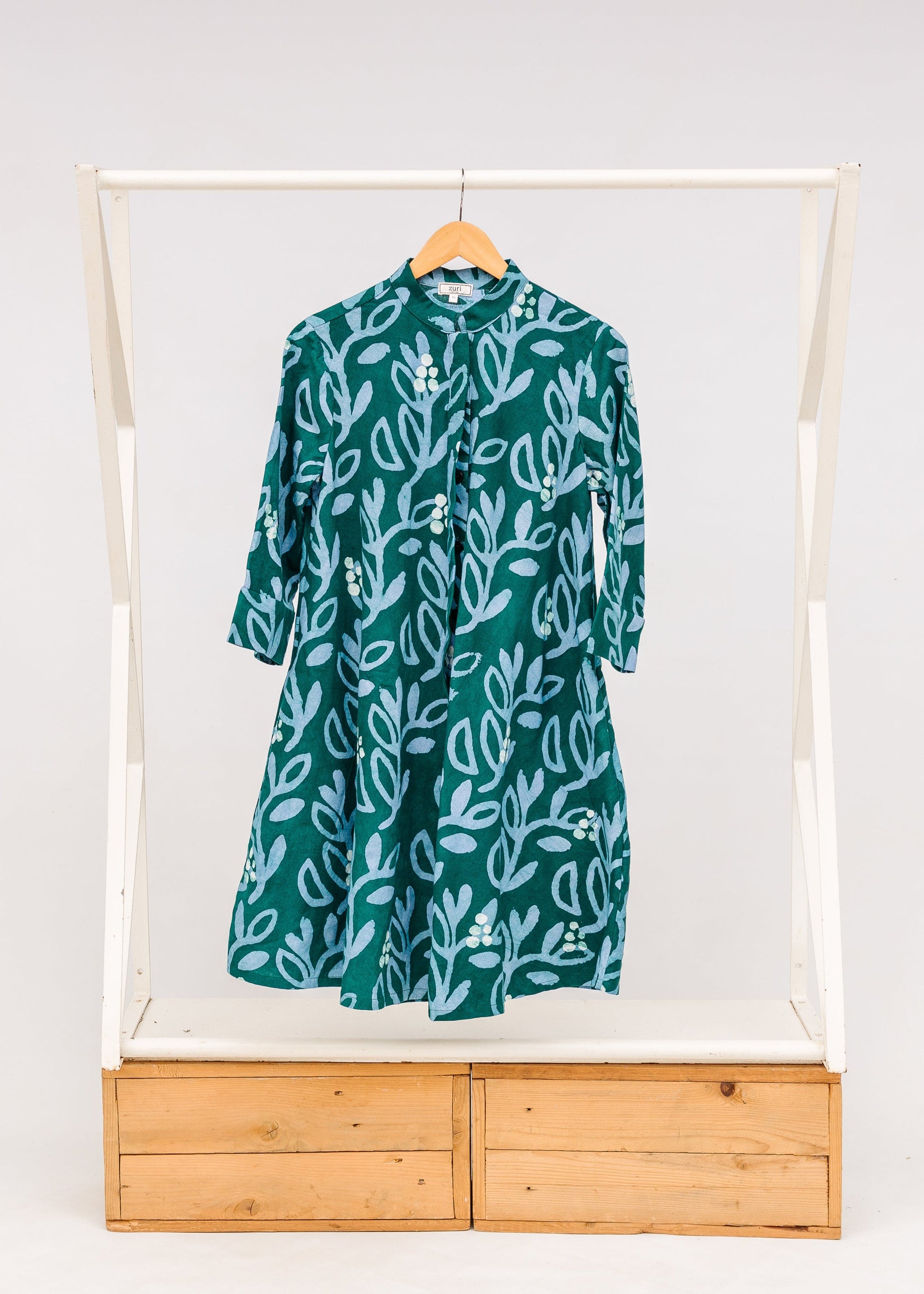 Display of green and blue floral batik dress.