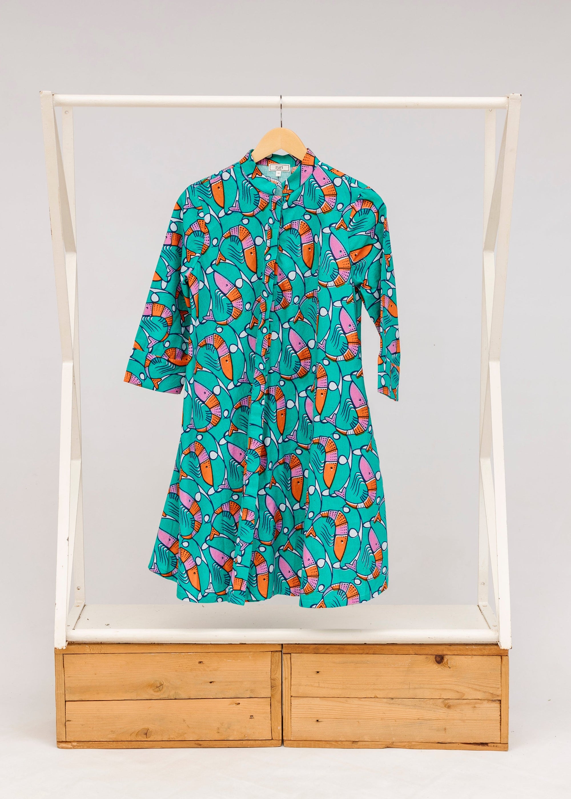 Display of teal dress with pink and orange shrimp print.