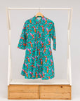 Display of teal dress with pink and orange shrimp print.