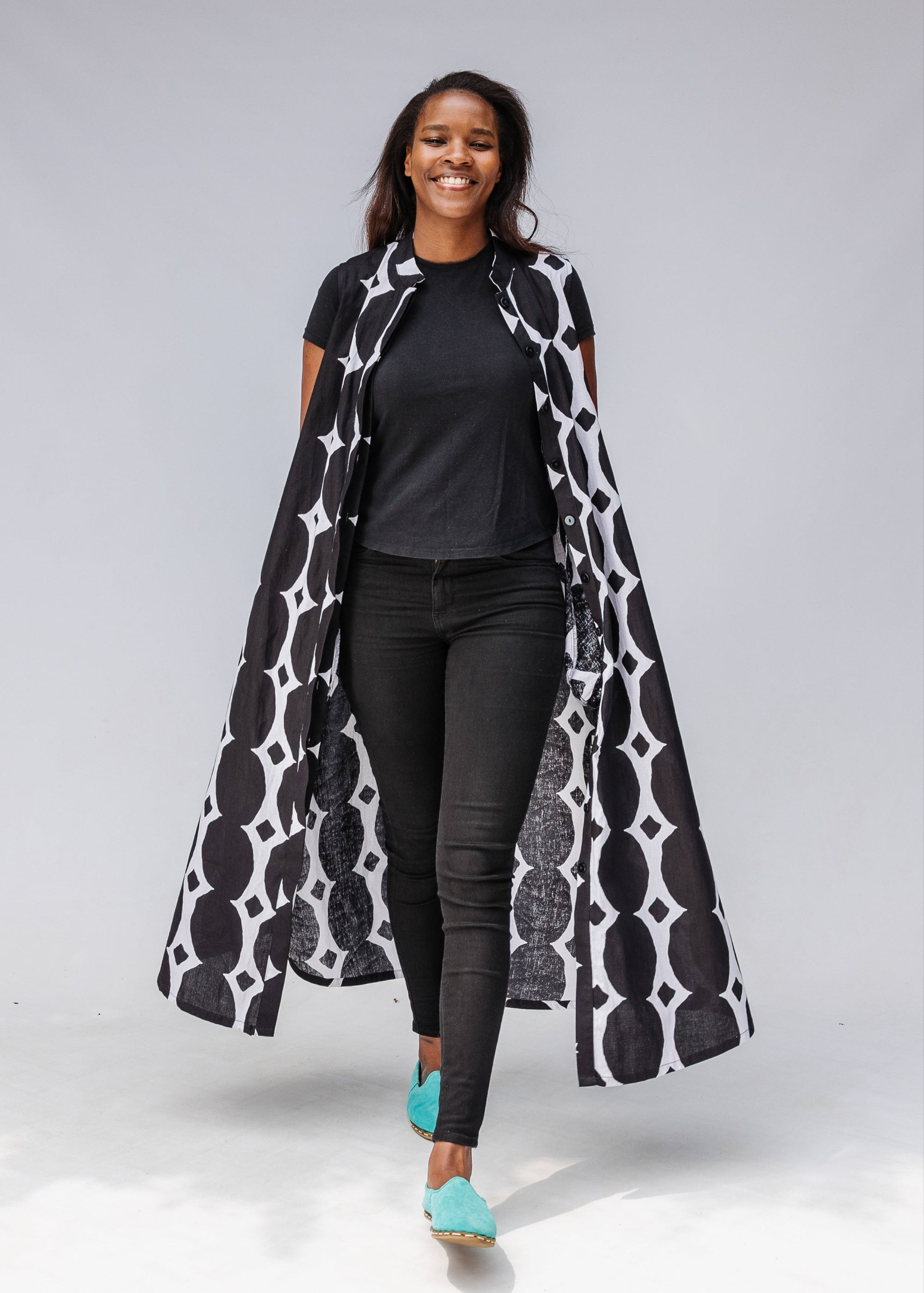 Model wearing black and white geometric print dress.