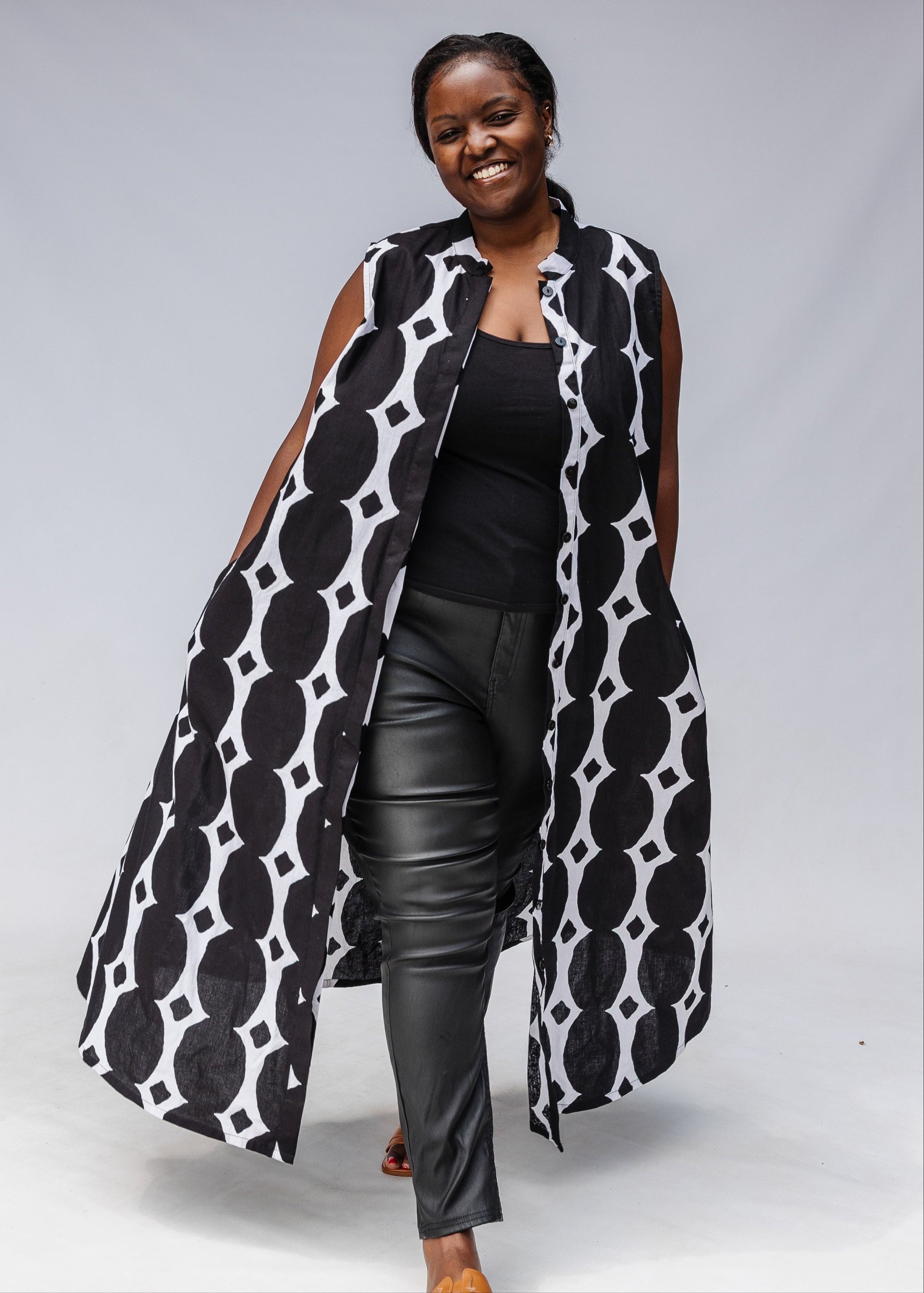 Model wearing black and white geometric print dress.