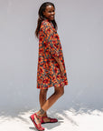 Model wearing butterfly print dress.