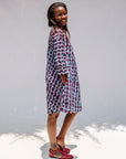 Model wearing purple and blue batik dress.