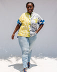 Model wearing mutlicolored batik shortsleeved shirt.