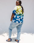 Model wearing mutlicolored batik shortsleeved shirt.