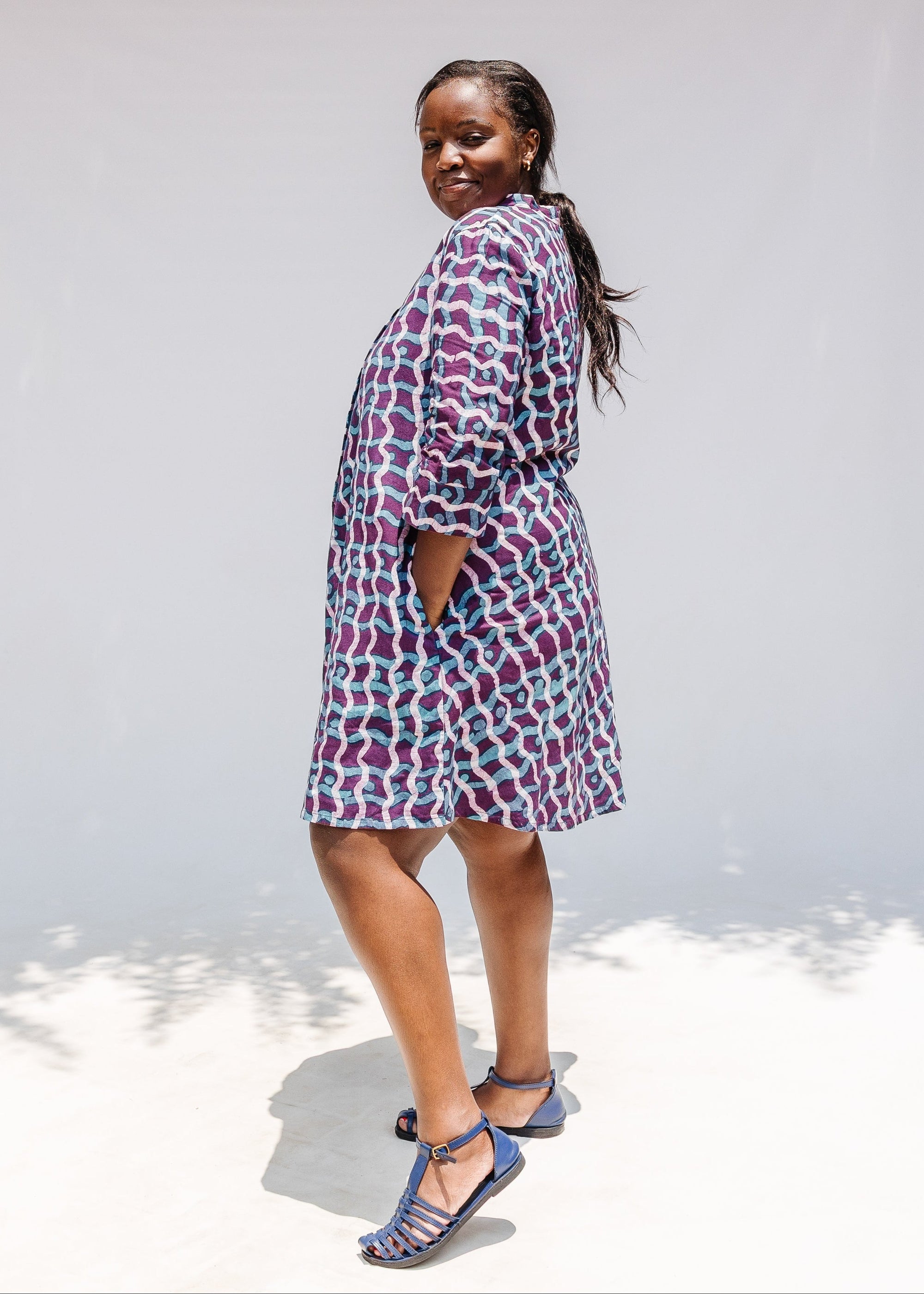 Model wearing purple and blue batik dress.