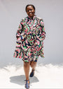 Model wearing colorful abstract print dress.