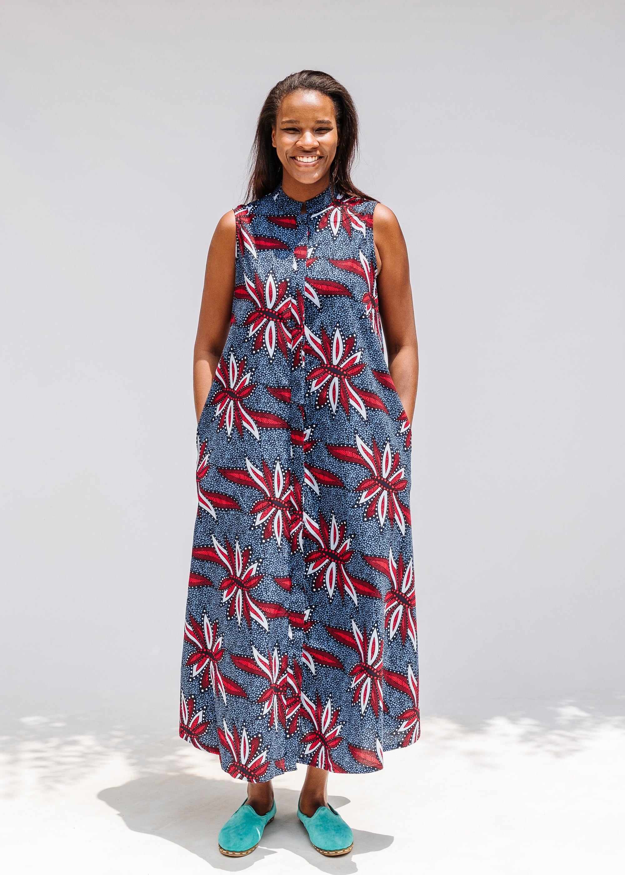 Model wearing grey, red and black dragonfly print dress.