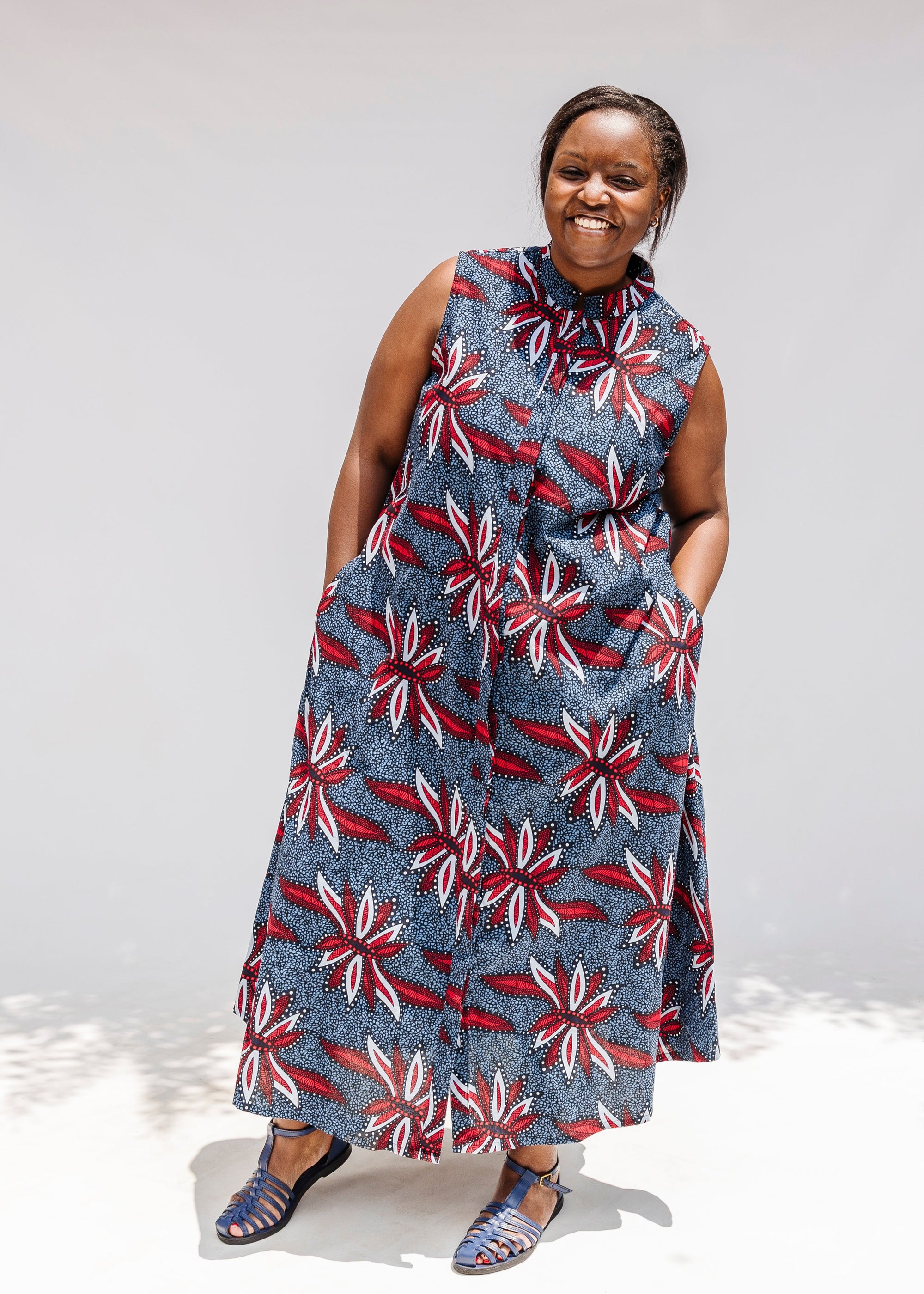 Model wearing grey, red and black dragonfly print dress.
